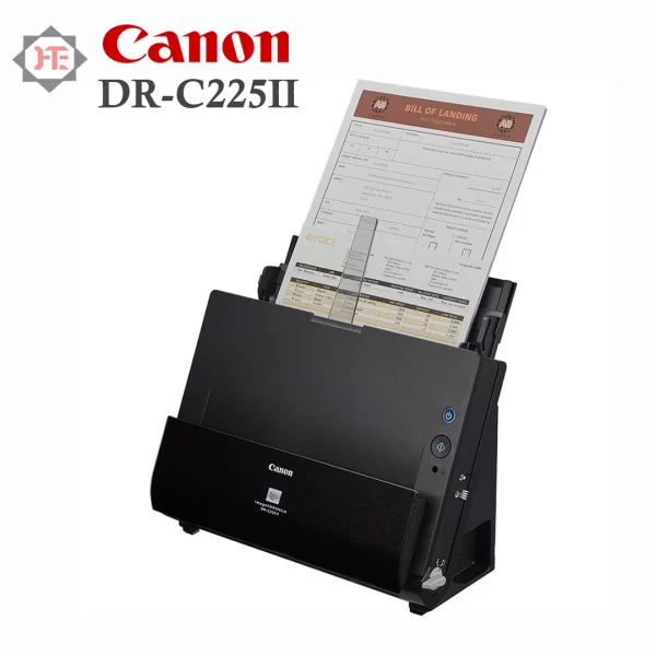 An image of the Canon DR C225 II document scanner on a white background. The scanner is a compact, black and gray device with a slightly curved design. The lid of the scanner is open to reveal a gray automatic document feeder (ADF) with several sheets of paper loaded into it. The front of the scanner has a small LCD display, a power button, and several other control buttons. The top of the scanner has a black panel with slots for paper input and output, and a lever to adjust the paper guides. The Canon logo is located on the front of the scanner.